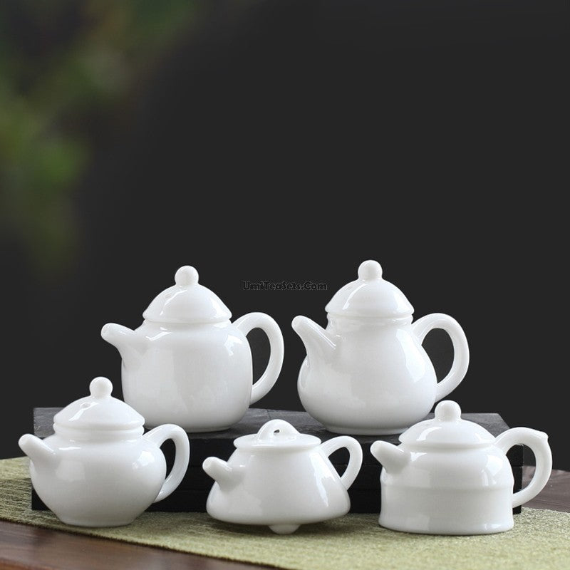 Top view of mini porcelain teapot showing translucent glaze and jade-like finish.