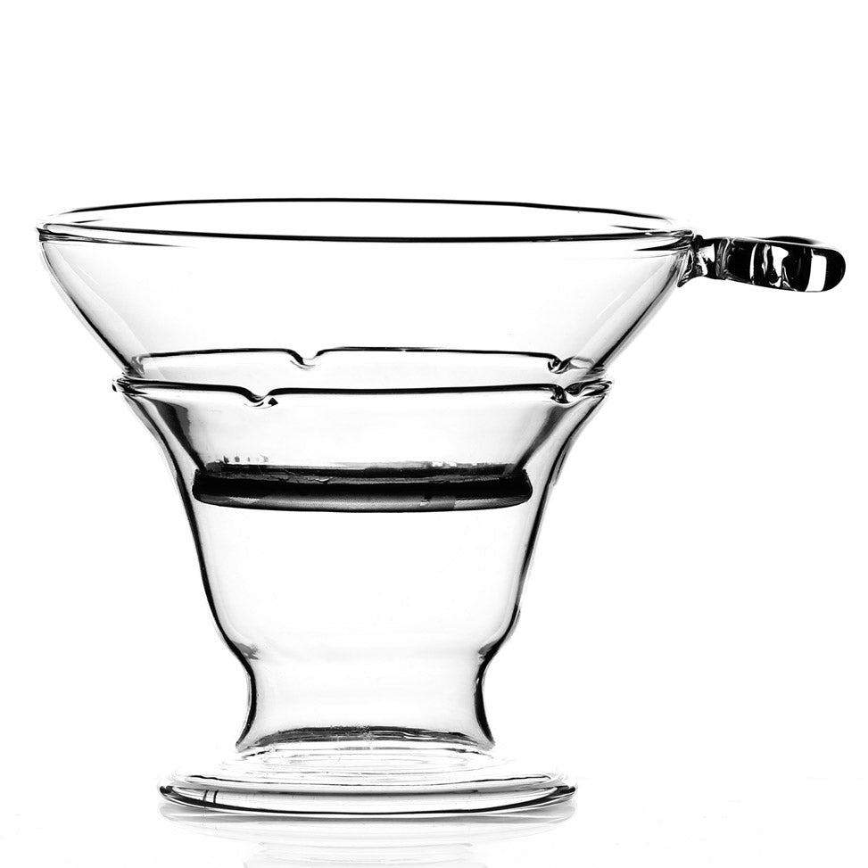 Clear glass tea strainer with holder, perfect for brewing loose leaf tea.
