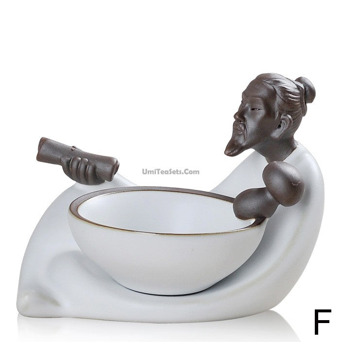 Front view of Ge Kiln tea infuser and holder set on a tea table