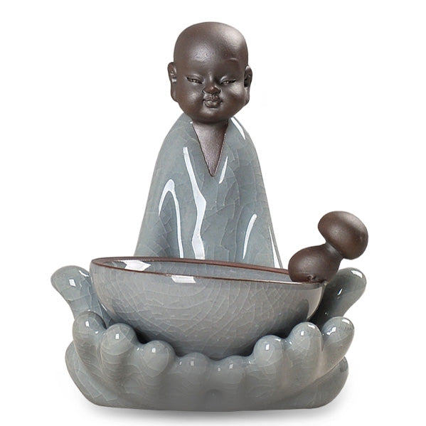 Front view of Ge Kiln tea infuser and holder set on a tea table
