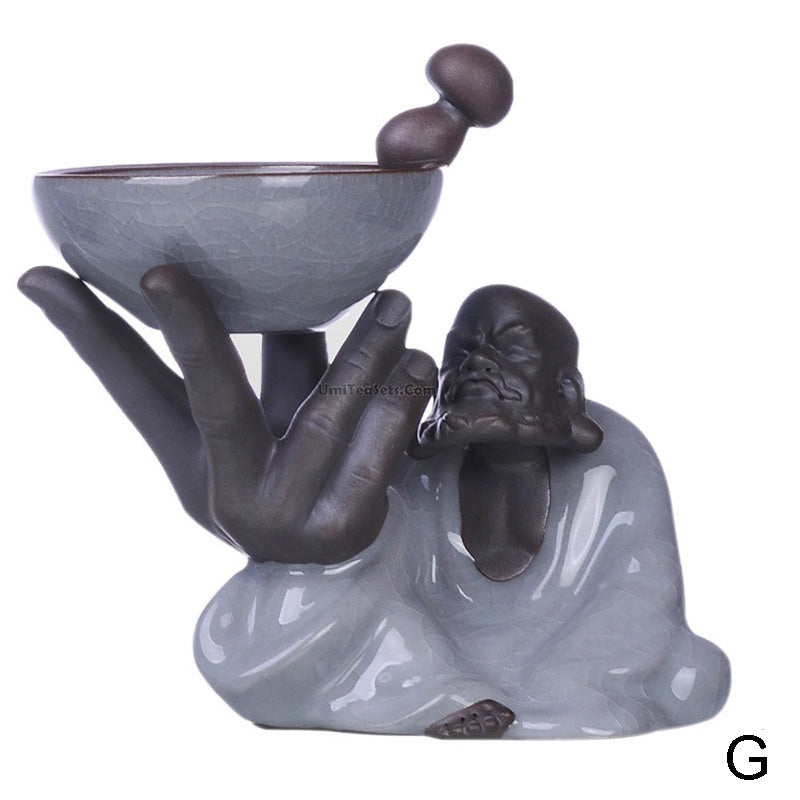 Tea infuser being used to pour brewed loose leaf tea into a cup