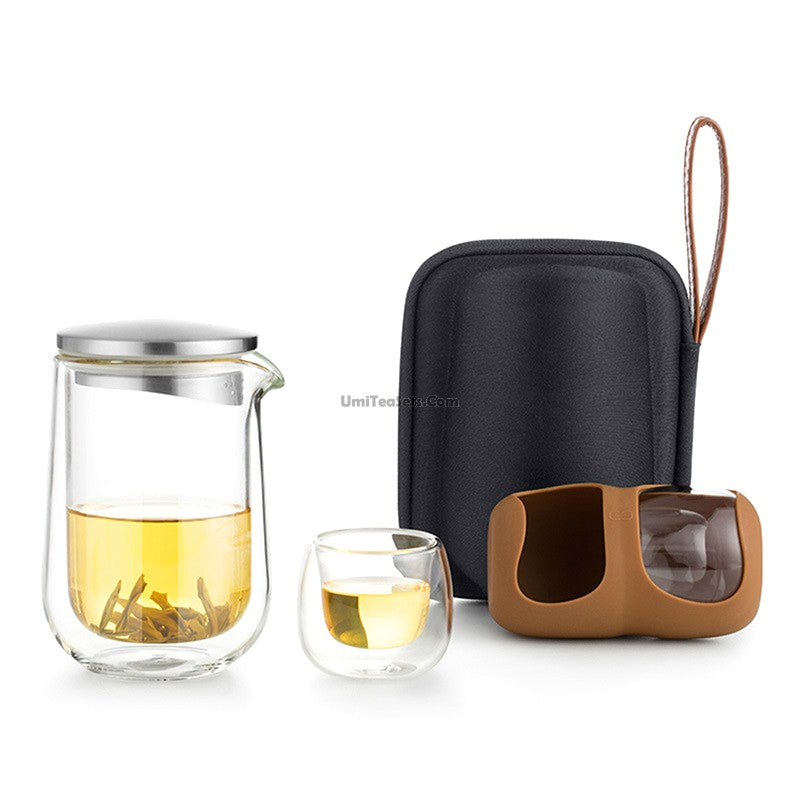 Elegant double wall glass travel tea set displayed with tea cups and teapot.