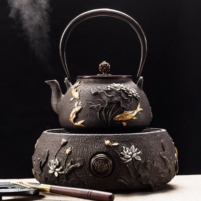 Close-up of cast iron teapot with fish and lotus carvings, designed for tea brewing and aesthetic appeal