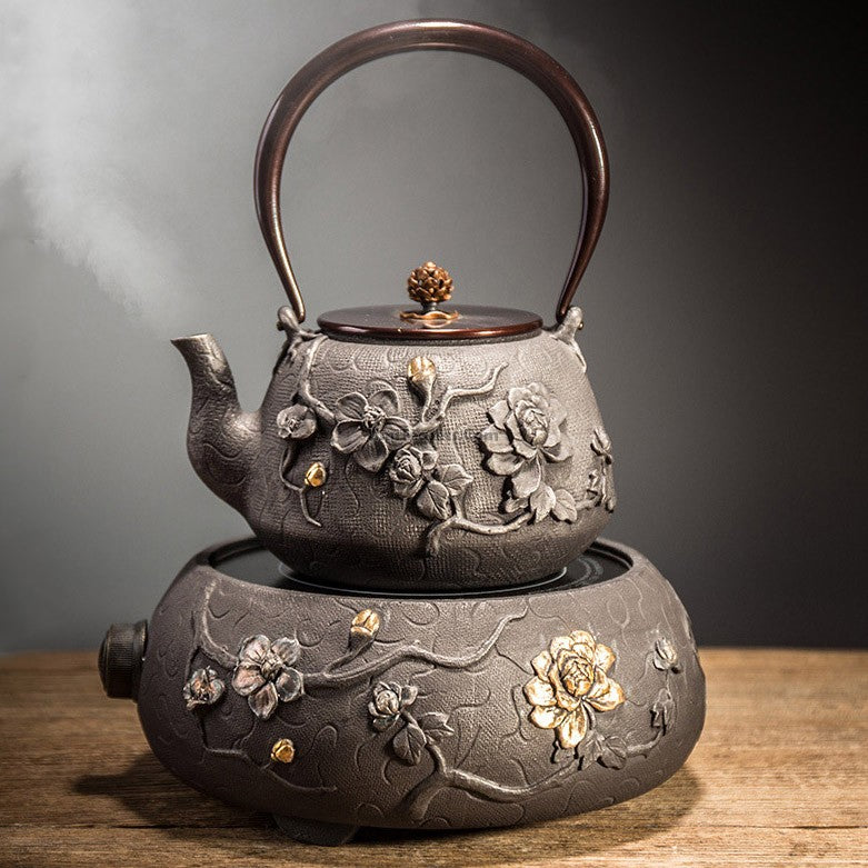 Magnolia cast iron teapot showcasing intricate floral design from a top angle.