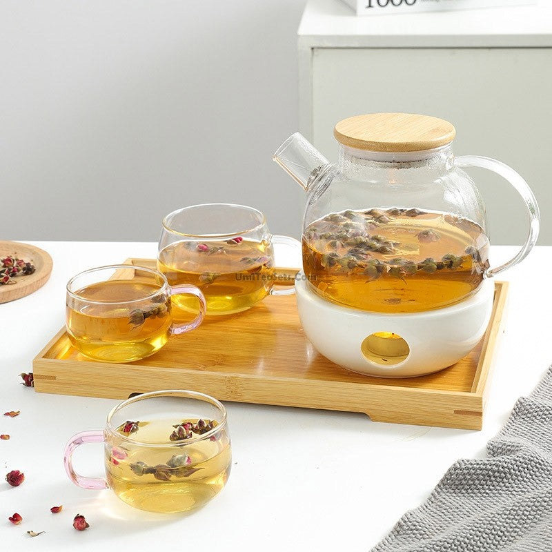 Elegant glass teapot with porcelain warmer angled view
