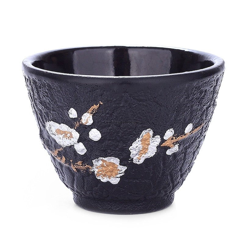 Close-up of a cast iron plum blossom tea cup with detailed floral design